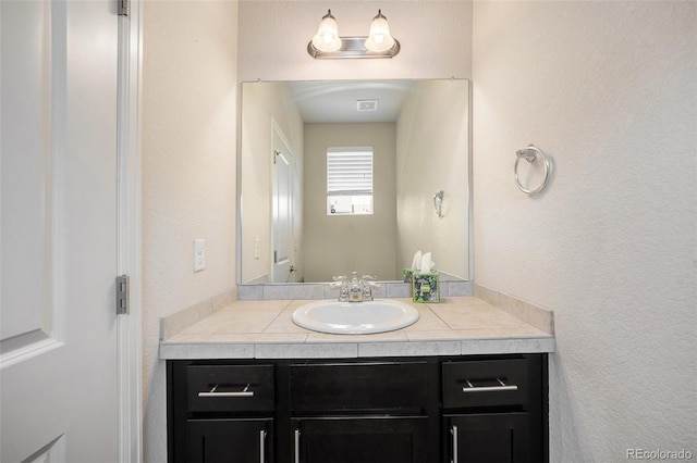 1732 Aspen Meadows Cir, Federal Heights, CO 80260 - bathroom with vanity and a textured wall