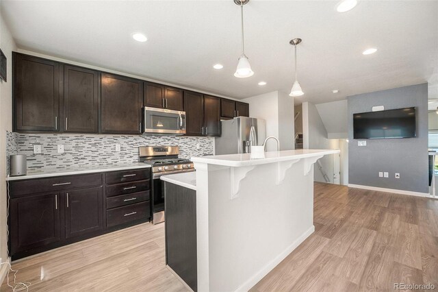 1732 Aspen Meadows Cir, Federal Heights, CO 80260 - kitchen featuring appliances with stainless steel finishes, light countertops, light wood finished floors, decorative backsplash, and recessed lighting