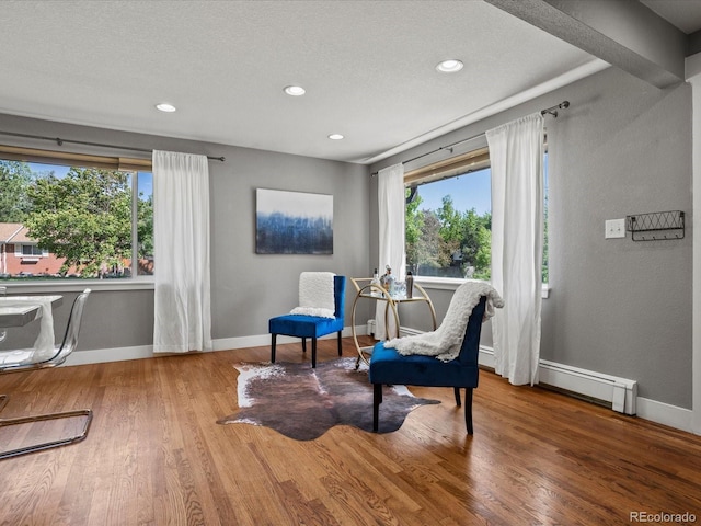 6943 Oak Way, Arvada, CO 80004 - sitting room with wood finished floors, recessed lighting, a baseboard radiator, and a textured ceiling