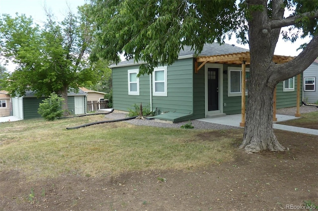 3575 W 9th Ave, Denver, CO 80204 - back of house featuring a yard, an outbuilding, a patio, and a shingled roof