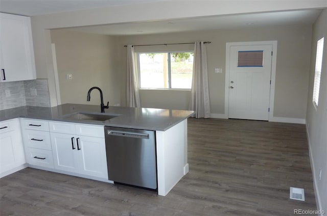3575 W 9th Ave, Denver, CO 80204 - kitchen with dishwasher, a peninsula, white cabinetry, decorative backsplash, and wood finished floors