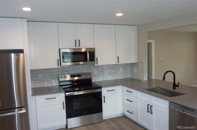 3575 W 9th Ave, Denver, CO 80204 - kitchen featuring appliances with stainless steel finishes, white cabinetry, and recessed lighting