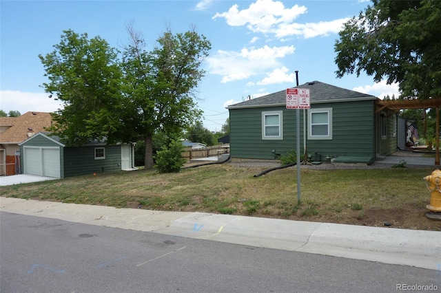 3575 W 9th Ave, Denver, CO 80204 - view of front of home featuring an outdoor structure, a front lawn, driveway, and a shingled roof