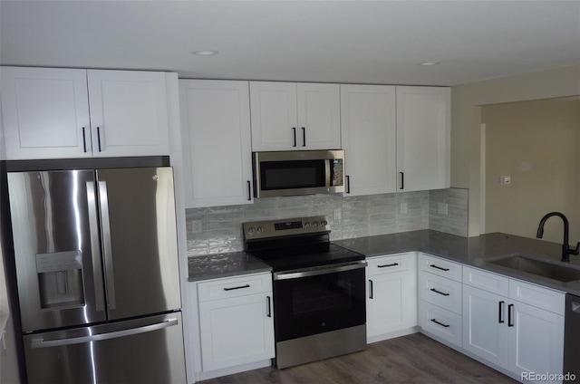 3575 W 9th Ave, Denver, CO 80204 - kitchen featuring appliances with stainless steel finishes, white cabinets, decorative backsplash, and recessed lighting