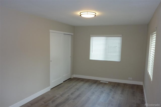 3575 W 9th Ave, Denver, CO 80204 - empty room featuring plenty of natural light and wood finished floors