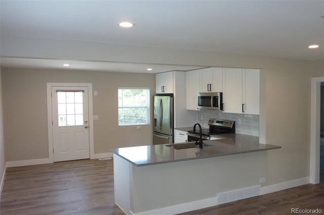 3575 W 9th Ave, Denver, CO 80204 - kitchen featuring stainless steel appliances, backsplash, dark wood-type flooring, recessed lighting, and white cabinets
