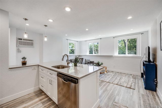 kitchen with white cabinetry, kitchen peninsula, pendant lighting, stainless steel dishwasher, and sink