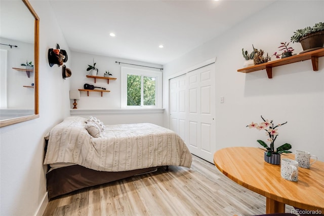 bedroom with a closet and light hardwood / wood-style flooring