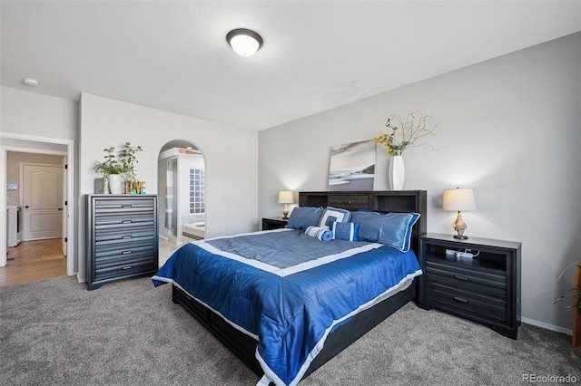10649 Mt Emerald Dr, Peyton, CO 80831 - carpeted bedroom featuring arched walkways, baseboards, and washer / dryer