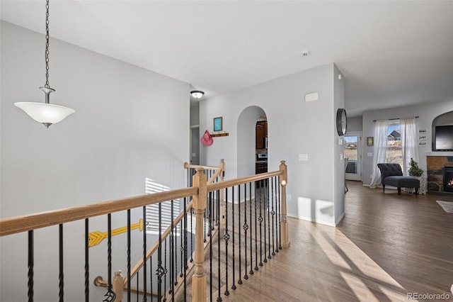 10649 Mt Emerald Dr, Peyton, CO 80831 - corridor with an upstairs landing, wood finished floors, arched walkways, and baseboards