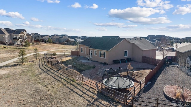 10649 Mt Emerald Dr, Peyton, CO 80831 - back of house featuring a residential view, stucco siding, and a fenced backyard