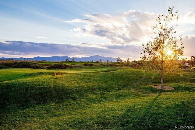 10649 Mt Emerald Dr, Peyton, CO 80831 - yard at dusk featuring a lawn, a mountain view, and golf course view