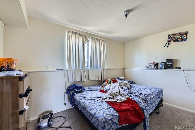 bedroom featuring carpet floors and baseboards