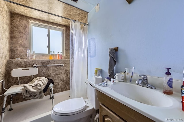 full bathroom featuring toilet, a shower stall, and vanity