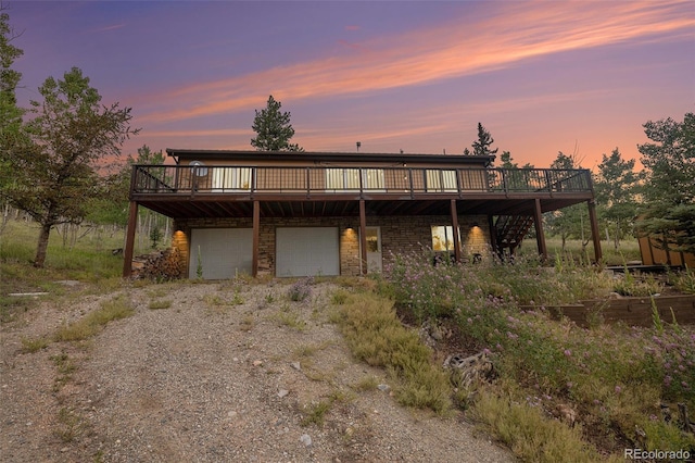 view of front of home with a deck and a garage