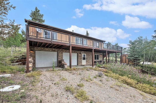 view of front of home featuring a storage unit, a deck, and a garage