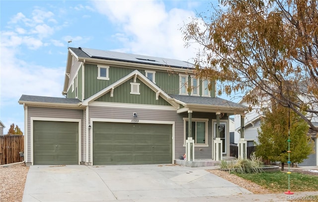 view of front of house featuring solar panels and a garage