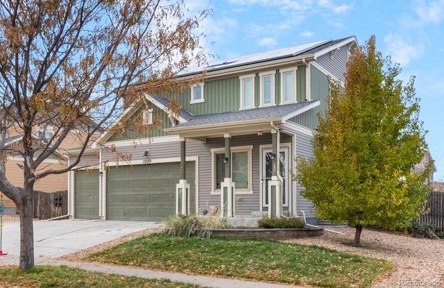 view of front of property featuring solar panels and a garage