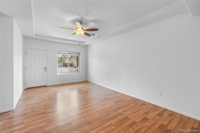 empty room featuring ceiling fan and light hardwood / wood-style floors