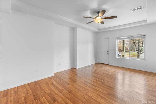 empty room with ceiling fan and light hardwood / wood-style floors