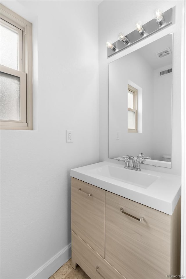 bathroom featuring vanity and a healthy amount of sunlight