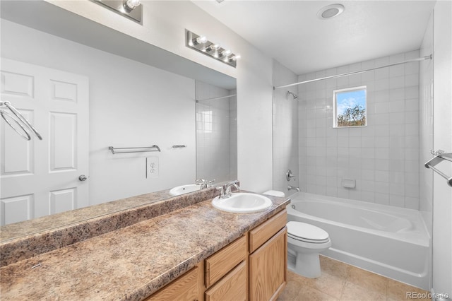 full bathroom with tile patterned floors, toilet, vanity, and tiled shower / bath