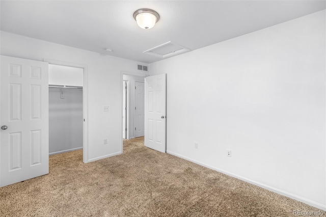 unfurnished bedroom with light carpet and a closet