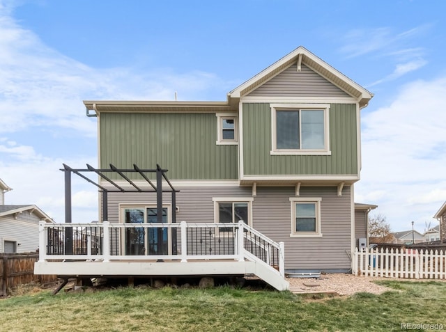 rear view of house featuring a pergola, a deck, and a yard