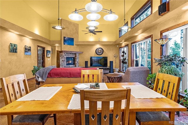 17595 Black Forest Rd, Colorado Springs, CO 80908 - dining room featuring a high ceiling, ceiling fan, and a fireplace