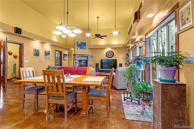 17595 Black Forest Rd, Colorado Springs, CO 80908 - dining area with a towering ceiling, finished concrete floors, a ceiling fan, and a fireplace