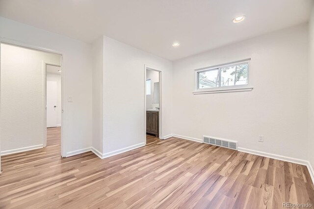 1325 Lima St, Aurora, CO 80010 - spare room featuring light wood-type flooring and recessed lighting