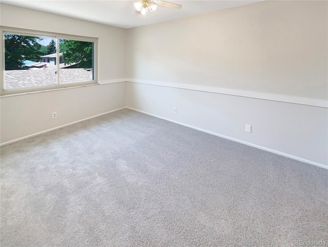 carpeted empty room featuring ceiling fan