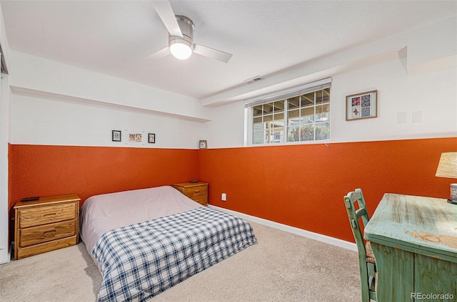 bedroom featuring light carpet, visible vents, a ceiling fan, and baseboards