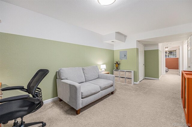 office space featuring a textured wall, light carpet, a textured ceiling, electric panel, and baseboards