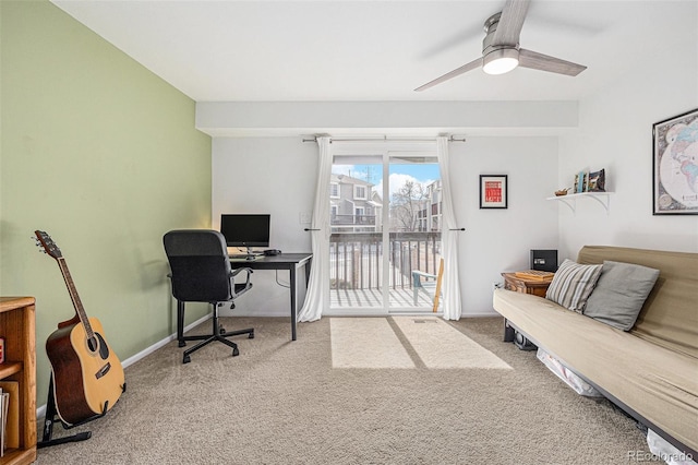 home office featuring carpet flooring, a ceiling fan, and baseboards