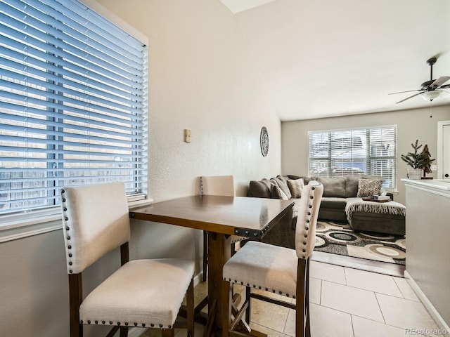 tiled dining room featuring ceiling fan