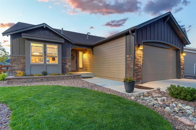 view of front of property featuring a lawn and a garage