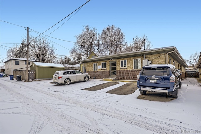 view of front of property with a shed