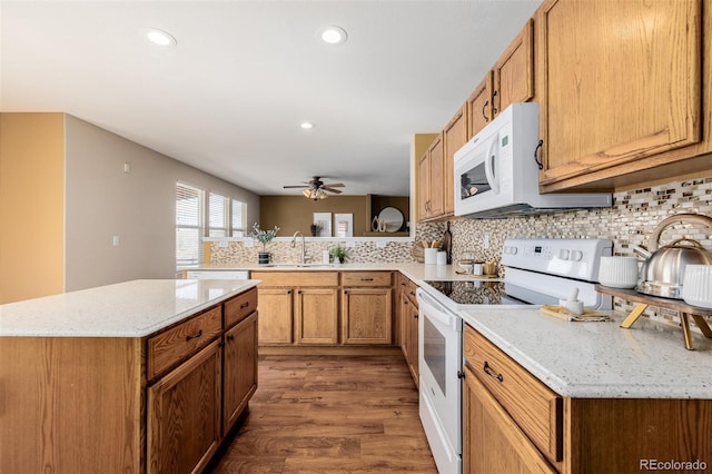 kitchen featuring decorative backsplash, white appliances, wood finished floors, and a ceiling fan