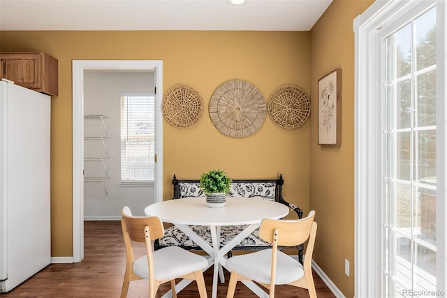 dining room featuring baseboards and wood finished floors