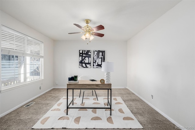 carpeted home office with visible vents, baseboards, and ceiling fan