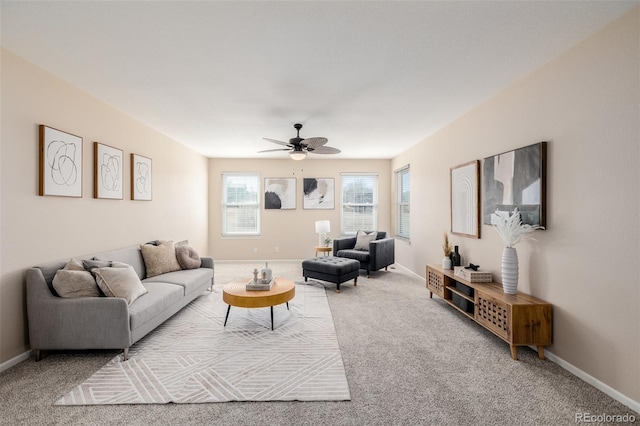 living area featuring carpet flooring, a ceiling fan, and baseboards