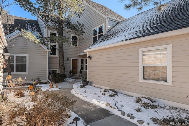 exterior space featuring a shingled roof