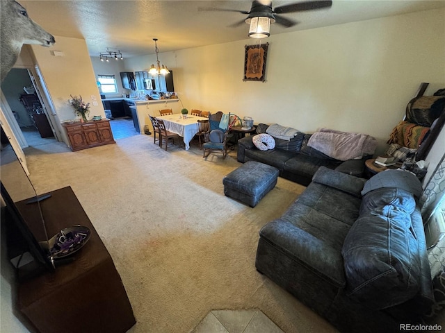 2874 Rose Hill St, Strasburg, CO 80136 - living area featuring light carpet, ceiling fan, and a chandelier