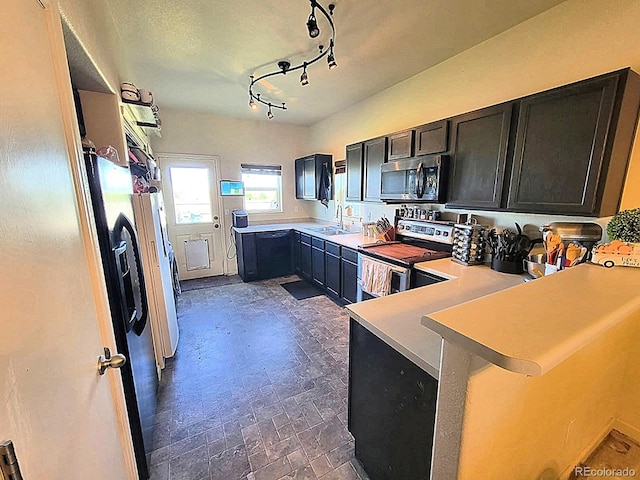 2874 Rose Hill St, Strasburg, CO 80136 - kitchen with appliances with stainless steel finishes, a peninsula, light countertops, and a kitchen breakfast bar