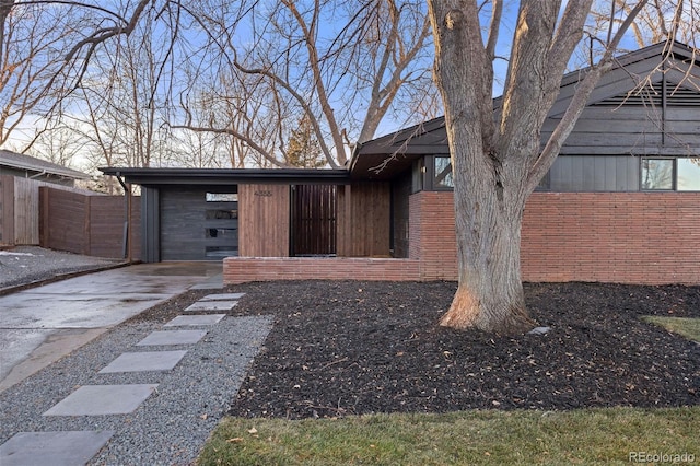 property entrance with a garage and a carport