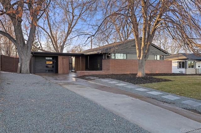 ranch-style house with a garage, a carport, and a front lawn