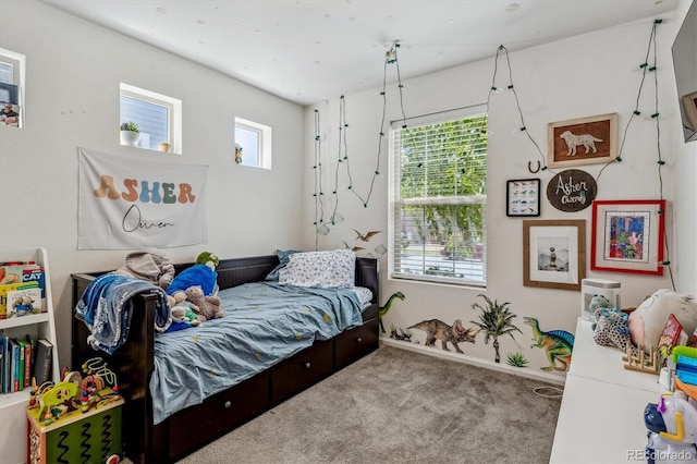 carpeted bedroom with baseboards