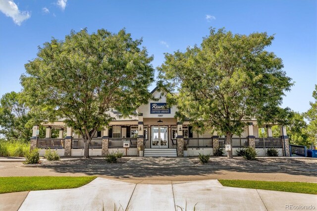 view of front of property with french doors and covered porch