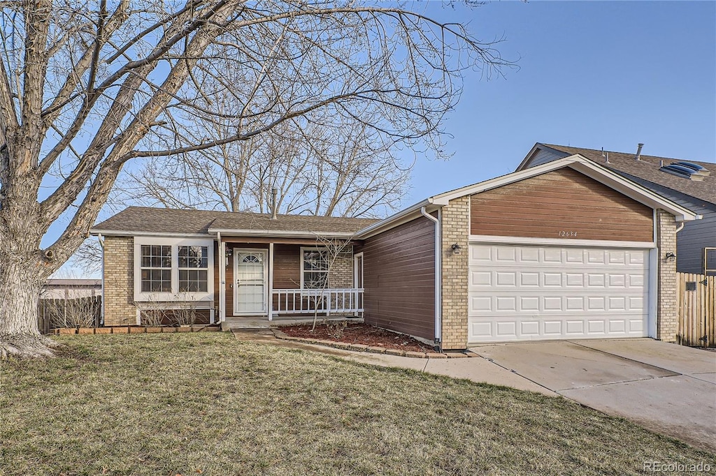 single story home featuring a garage and a front lawn